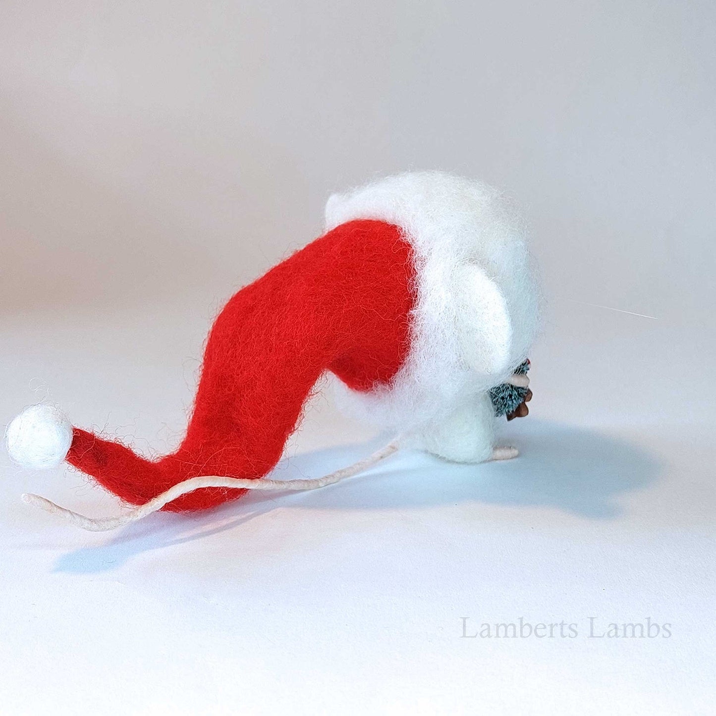 Adorable needle felted Christmas mouse in a Santa hat holding a wreath decorated with cookies/ White wool felted mouse keepsake decoration