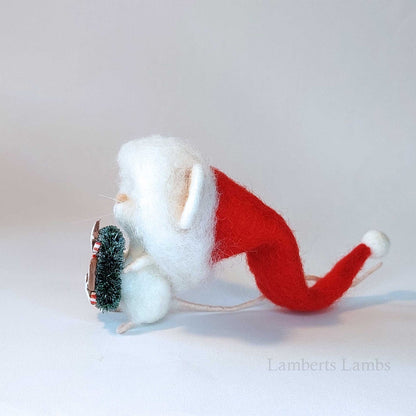 Adorable needle felted Christmas mouse in a Santa hat holding a wreath decorated with cookies/ White wool felted mouse keepsake decoration