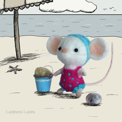 White needle felted mouse in a one piece pink swimsuit with blue pok-a-dots and beach pail