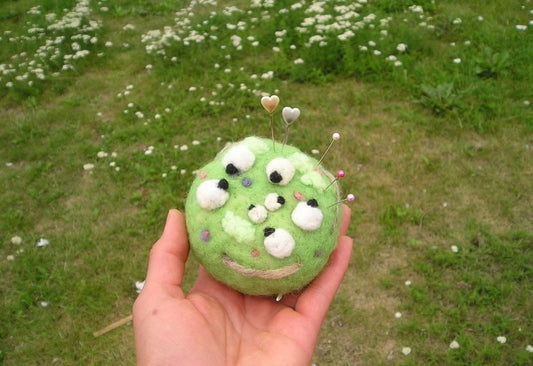 Needle felted pin cushion of sheep in the meadow